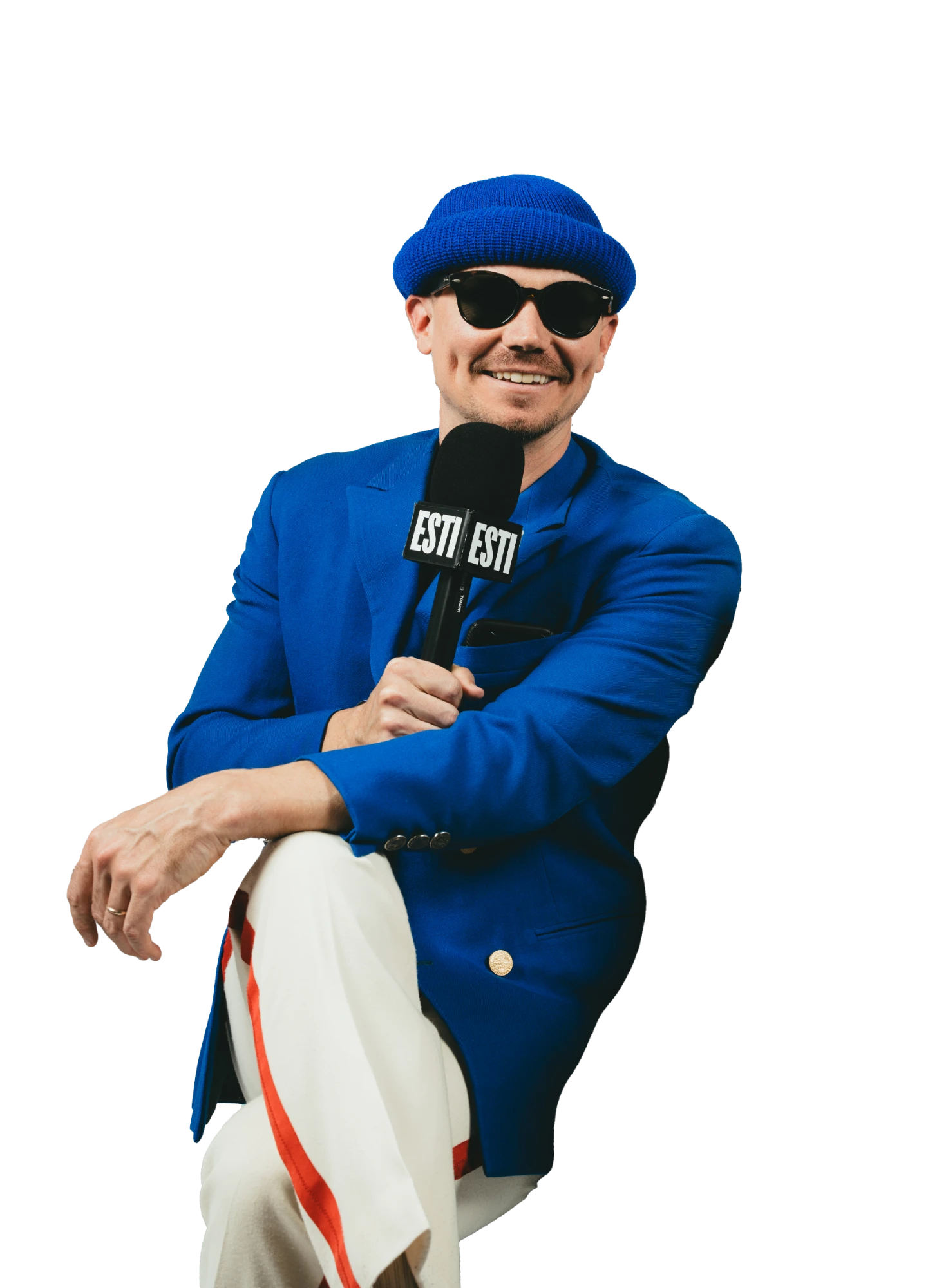 Kyle, in a blue blazer and beanie, holding an ESTI mic
